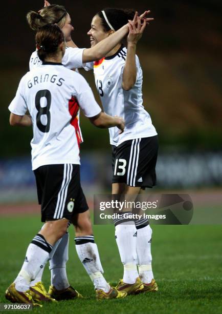 Alexandra Popp of Germany celebrates with team mates Inka Grings and Celia Okoyino da Mbabi during the Woman's Algarve Cup match between Germany and...