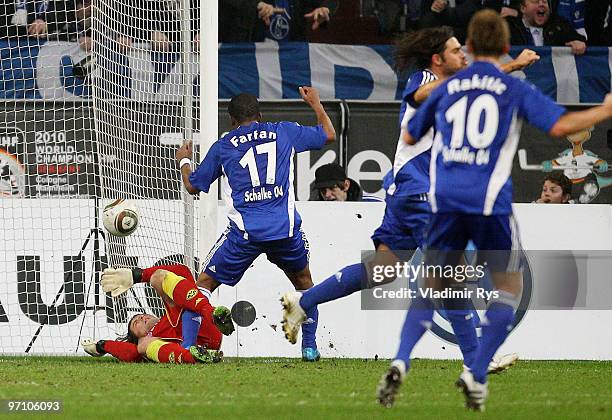 Goalkeeper Roman Weidenfeller of Dortmund receives a goal scored by Benedikt Hoewedes of Schalke during the Bundesliga match between FC Schalke 04...