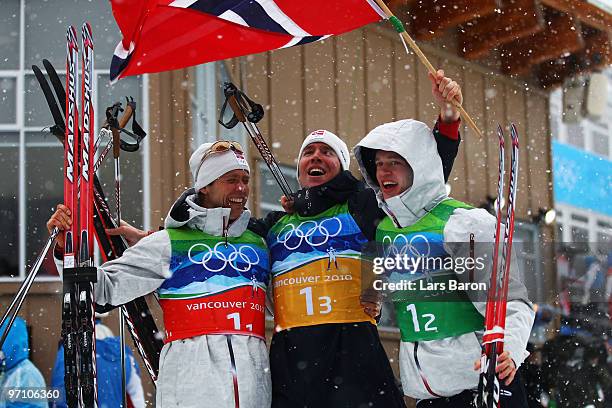 Halvard Hanevold, Emil Hegle Svendsen and Tarjei Boe of Norway celebrate winning the gold medal during the men's 4 x 7.5 km biathlon relay on day 15...