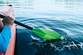 kayaker paddles across a serene lake