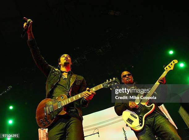 Musician Michael Franti and bass player Carl Young perform at Madison Square Garden on February 25, 2010 in New York City.