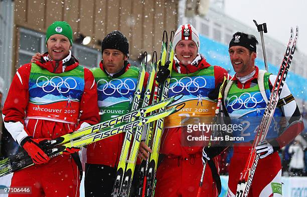 Simon Eder, Daniel Mesotitsch, Dominik Landertinger and Christoph Sumann of Austria celebrate winning the silver medal during the men's 4 x 7.5 km...