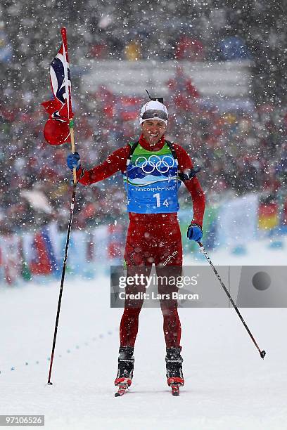 Ole Einar Bjoerndalen of Norway crosses the finish line to win the gold medal in the men's 4 x 7.5 km biathlon relay on day 15 of the 2010 Vancouver...