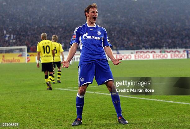 Benedikt Hoewedes of Schalke celebrates after scoring his team's first goal during the Bundesliga match between FC Schalke 04 and Borussia Dortmund...