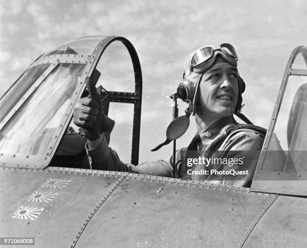 Navy flying ace Commander John Thach gives a thumbs up from the cockpit of his plane, June 1942.