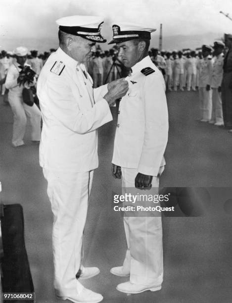 Navy Vice Admiral William F Halsey Jr awards the Navy Cross to Lieutenant Commander James H Flatley Jr , 1942. Flatley was honored for his...