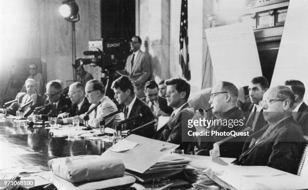 View of members of the US Senate's Committee on Activities in the Labor and Management Field as they sit a ta table during a hearing, Washington DC,...