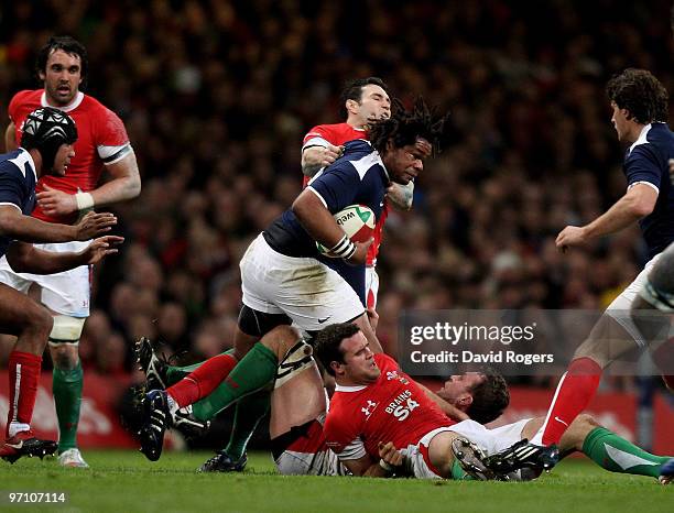 Mathieu Bastareaud of France is tackled by Stephen Jones of Wales during the RBS Six Nations match between Wales and France at the Millennium Stadium...
