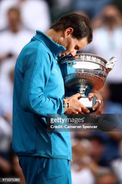 Rafael Nadal of Spain holds the Musketeers' Cup as he celebrates victory following the mens singles final against Dominic Thiem of Austria during day...
