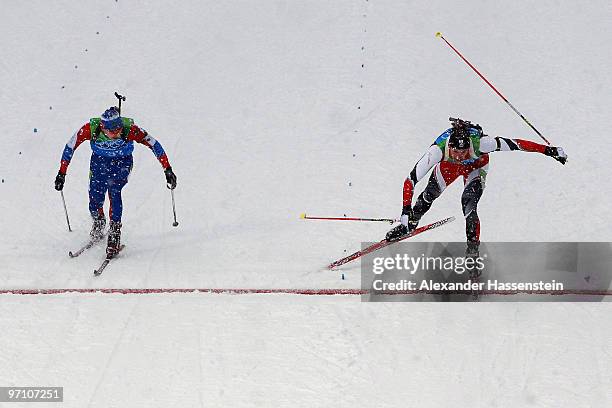 Christoph Sumann of Austria crosses the finish line to win the silver medal ahead of Evgeny Ustyugov of Russia during the men's 4 x 7.5 km biathlon...