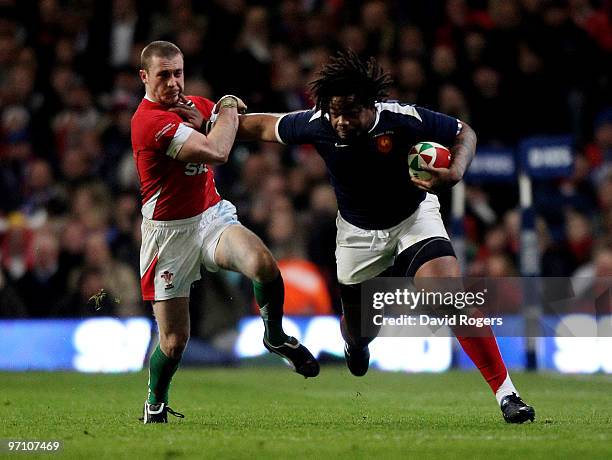 Mathieu Bastareaud of France races away from Richie Rees during the RBS Six Nations match between Wales and France at the Millennium Stadium on...