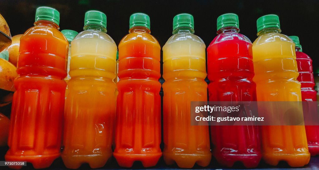 Close-up of apple juice bottles for sale