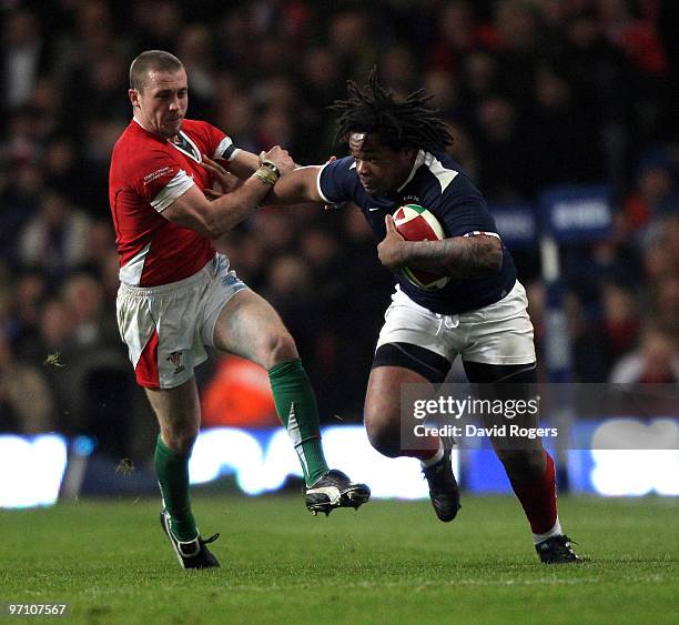 Mathieu Bastareaud of France races away from Richie Rees during the RBS Six Nations match between Wales and France at the Millennium Stadium on...