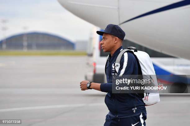 France's national football team forward Kylian Mbappe disembarks from a plane after landing at Moscow Sheremetyevo airport in Khimki on June 10 ahead...