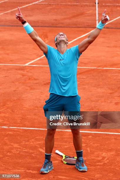 Rafael Nadal of Spain celebrates victory following the mens singles final against Dominic Thiem of Austria during day fifteen of the 2018 French Open...