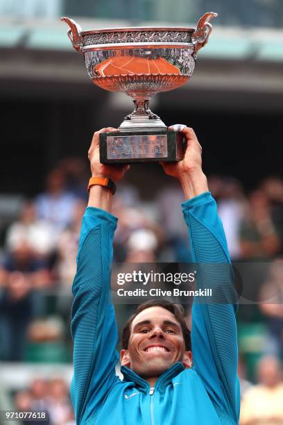 Rafael Nadal of Spain lifts the Musketeers' Cup as he celebrates victory following the mens singles final against Dominic Thiem of Austria during day...