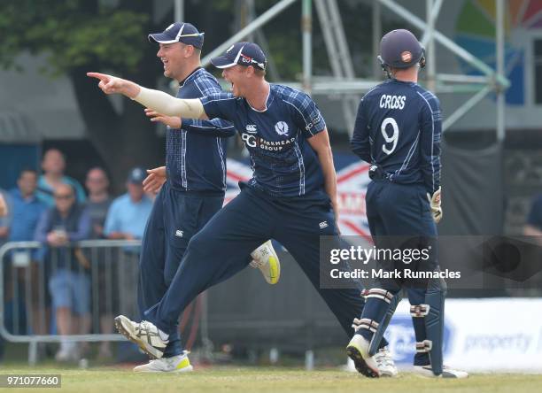 Alasdair Evans, Matthew Cross, and Mark Watt of Scotland celebrates taking the wicket of Alex Hales during the One Day International match between...