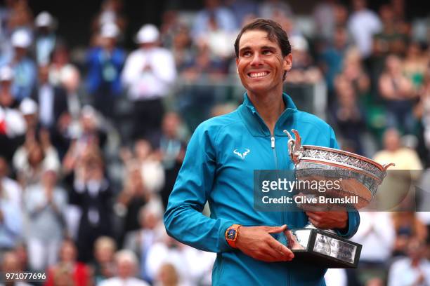 Rafael Nadal of Spain hugs the Musketeers' Cup as he celebrates victory following the mens singles final against Dominic Thiem of Austria during day...