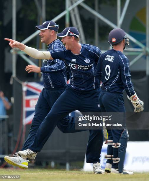 Alasdair Evans, Matthew Cross, and Mark Watt of Scotland celebrates taking the wicket of Alex Hales during the One Day International match between...