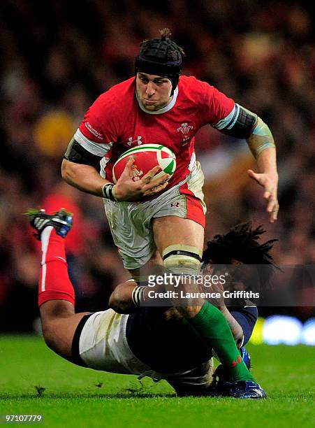Ryan Jones of Wales is tackled by Mathieu Bastareaud of France during the RBS Six Nations Championship match between Wales and France at the...