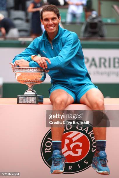 Rafael Nadal of Spain holds the Musketeers' Cup as he celebrates victory following the mens singles final against Dominic Thiem of Austria during day...