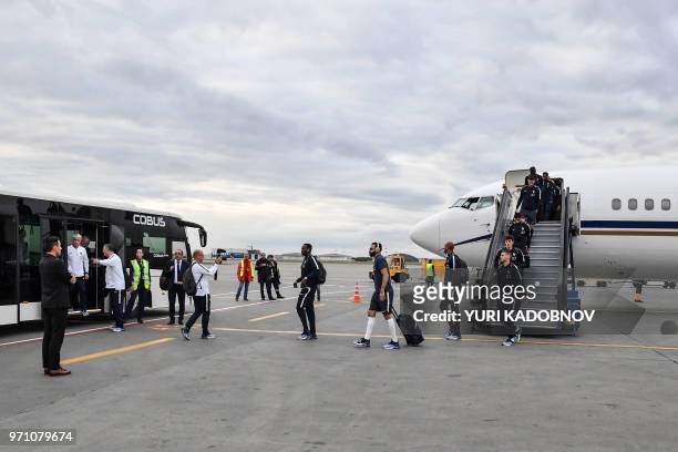 France's national football players disembark from a plane after landing at Moscow Sheremetyevo airport in Khimki on June 10 ahead of the Russia 2018...