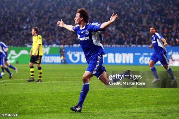 Benedikt Hoewedes of Schalke celebrates after scoring his team's first goal during the Bundesliga match between FC Schalke 04 and Borussia Dortmund...