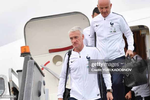 France's national football coach coach Didier Deschamps and assistant coach Guy Stephan disembark from a plane after landing at Moscow Sheremetyevo...