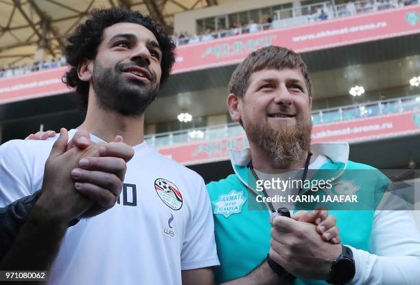 Egyptian national football team player and Liverpool's star striker Mohamed Salah poses with head of the Chechen Republic Ramzan Kadyrov during a...