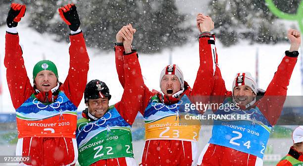 Austria's silver medalists Simon Eder, Daniel Mesotitsch, Dominik Landertinger and Christoph Sumann attend the podium ceremony for the men's Biathlon...