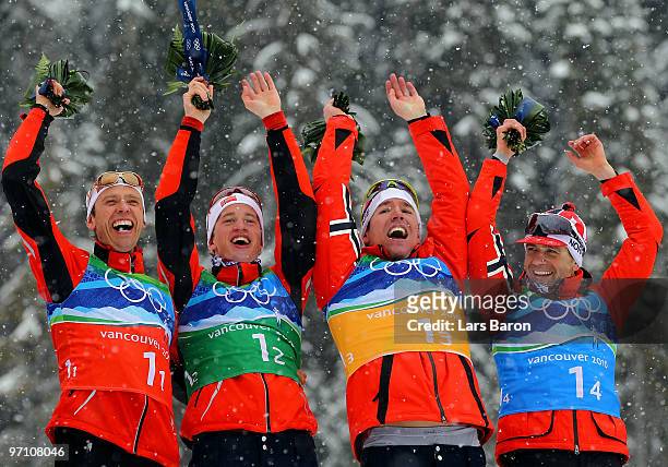 Halvard Hanevold, Tarjei Boe, Emil Hegle Svendsen and Ole Einar Bjoerndalen of Norway celebrate winning the gold medal during the flower ceremony for...