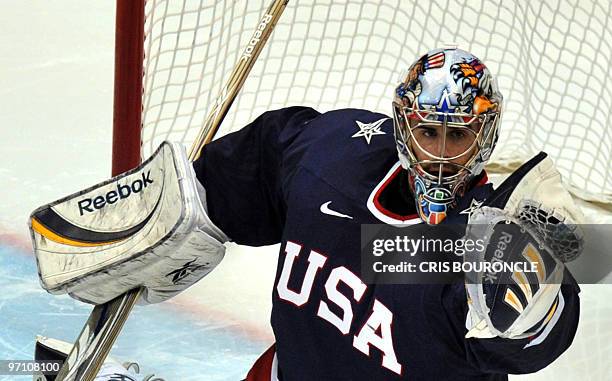 S goalkeeper Ryan Miller catches the puck during the Men's Semifinals Medal Hockey game between the USA and Finland at the Canada Hockey Place during...