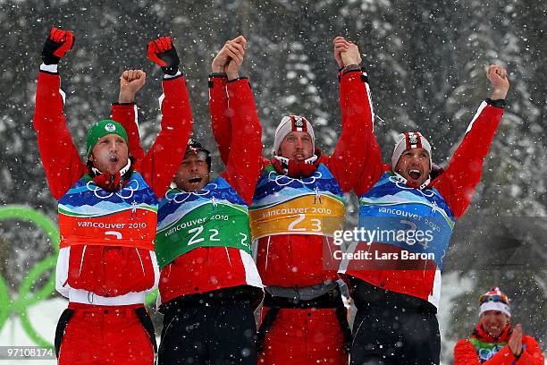 Simon Eder, Daniel Mesotitsch, Dominik Landertinger and Christoph Sumann of Austria celebrate winning the silver medal during the flower ceremony for...