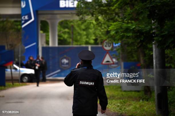 Policeman stands guard at the entrance of the hotel of France's national football team prior to the arrival of players, on June 10 in the village of...