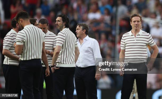 Damian Lewis of England stands on the pitch alongside Blake Harrison of England and Bradley Walsh assistant manager of England and team mates prior...
