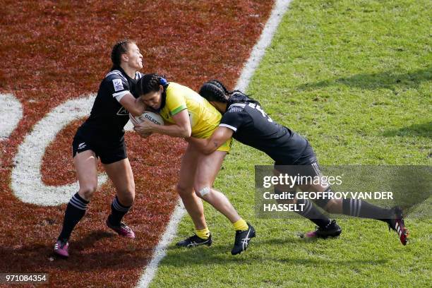 Australia's Charlotte Caslick is tackled by New Zealand's Sarah Goss during the final of the Women's tournament of 2018 Rugby World Cup Sevens game...