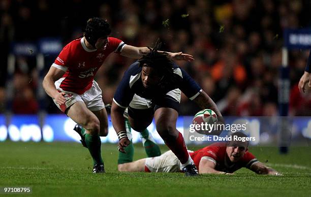 Mathieu Bastareaud of France races away from Richie Rees and Leigh Halfpenny during the RBS Six Nations match between Wales and France at the...