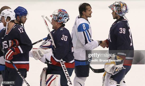 Goalkeeper Ryan Miller of the United States greets Teemu Selanne of Finland after the ice hockey men's semifinal game between the United States and...