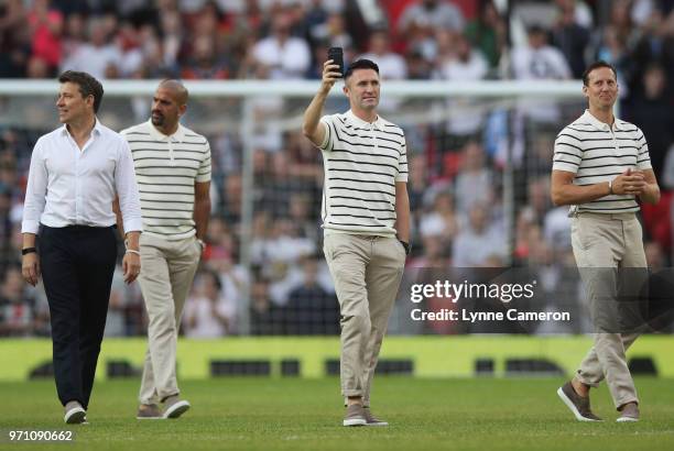 Robbie Keane of the Rest of the World walks on the pitch with fellow palyers prior to the Soccer Aid for UNICEF 2018 match between England and the...