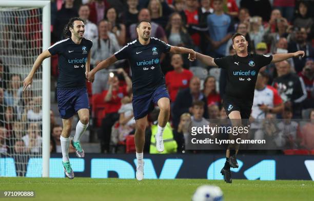 Blake Harrison of England, Paddy McGuinness of England and Danny O'Carroll of the Rest of the World warm up prior to the Soccer Aid for UNICEF 2018...
