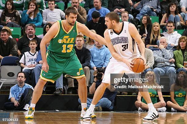 Spencer Hawes of the Utah Jazz looks to move the ball against Mehmet Okur of the Sacramento Kings during the game at EnergySolutions Arena on January...