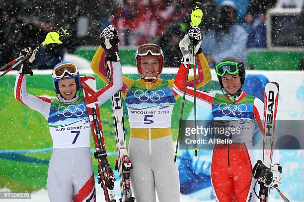 Marlies Schild of Austria, Maria Riesch of Germany and Sarka Zahrobska of Czech Republic celebrate after crossing the finish line during the Ladies...
