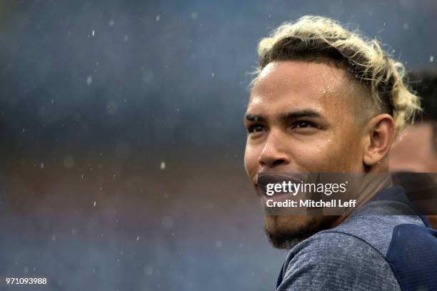 Orlando Arcia of the Milwaukee Brewers watches the game against the Philadelphia Phillies in the rain from the dugout at Citizens Bank Park on June...