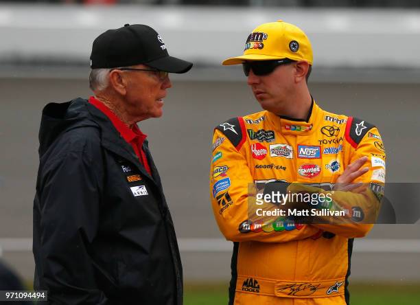 Team owner, Joe Gibbs, speaks with Kyle Busch, driver of the M&M's Red White & Blue Toyota, during a weather delay for the Monster Energy NASCAR Cup...