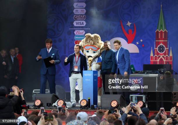 Ambassadors Aleksandr Kerzhakov and Marcel Desailly pose with the FIFA World Cup trophy along with mascot Zabivaka during the official opening of the...