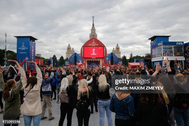 People attend the official opening ceremony of the FIFA Fan Fest in Moscow, near the main building of the Lomonosov Moscow State University in...