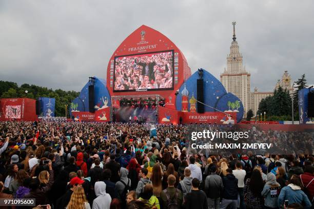 People attend the official opening ceremony of the FIFA Fan Fest in Moscow, near the main building of the Lomonosov Moscow State University in...