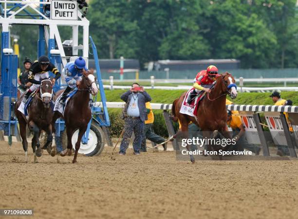 Justify, ridden by Jockey Mike Smith, takes the lead out of the gate before on his way to winning the 150th running of the Belmont Stakes and with...