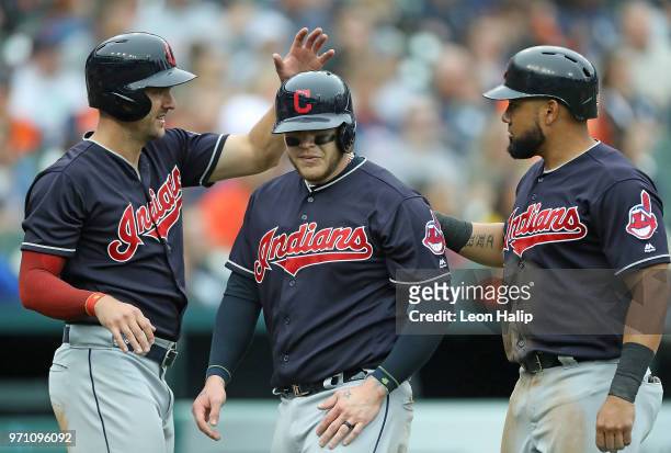 Lonnie Chisenhall of the Cleveland Indians celebrates with teammates Roberto Perez and Melky Cabrera of the Cleveland Indians after scoring on the...