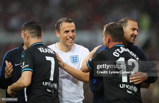 Phil Neville of England shakes hands with opponents prior to the Soccer Aid for UNICEF 2018 match between England and the Rest of the World at Old...